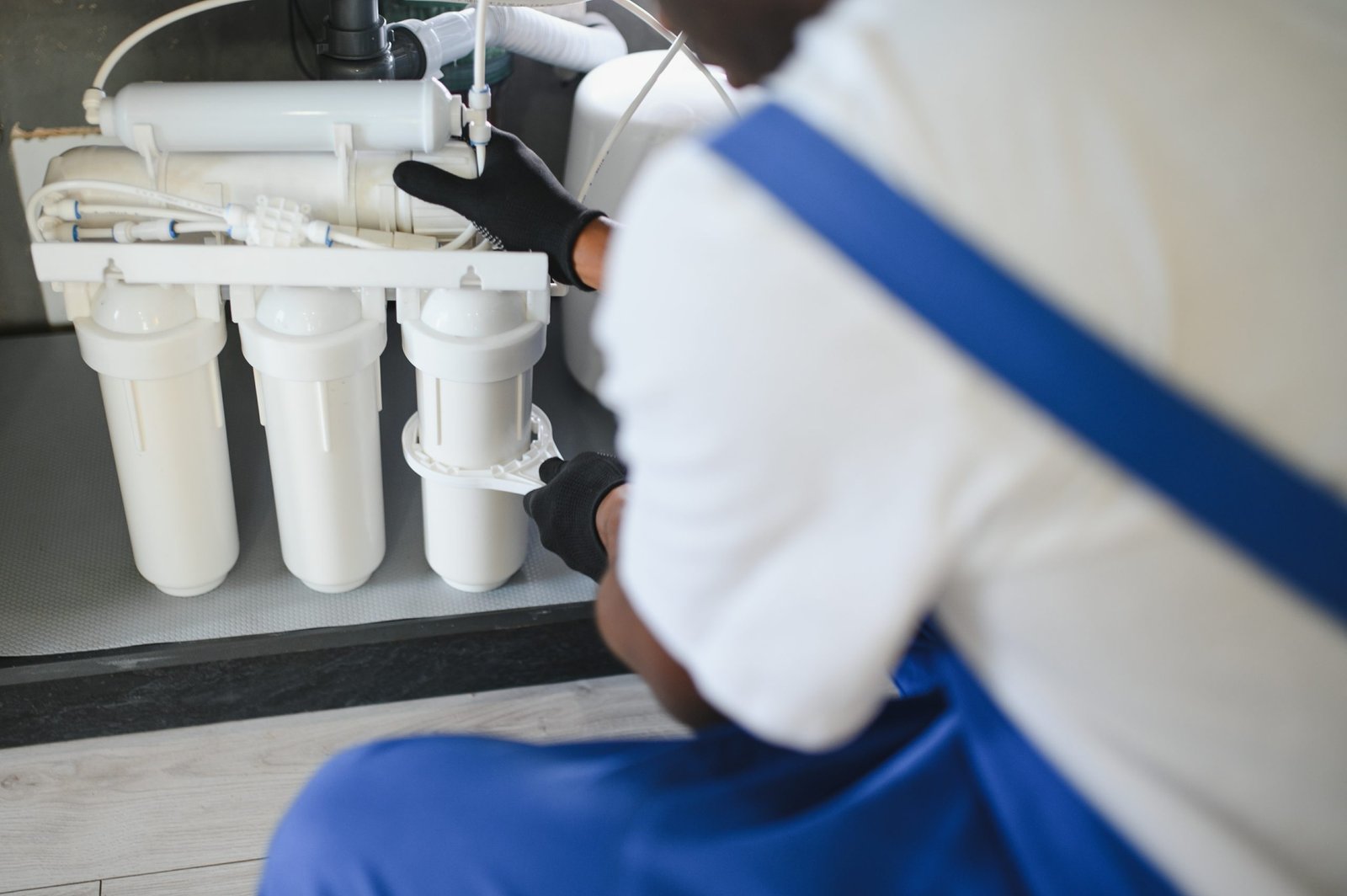 Plumber Installing Water Filter