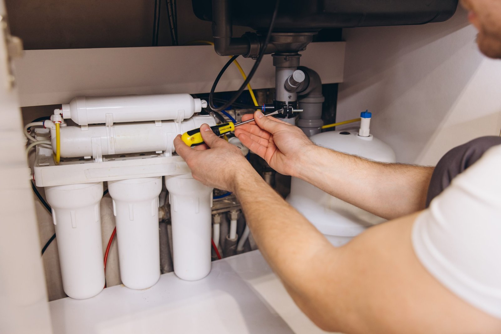 Plumber Installing Water Filter